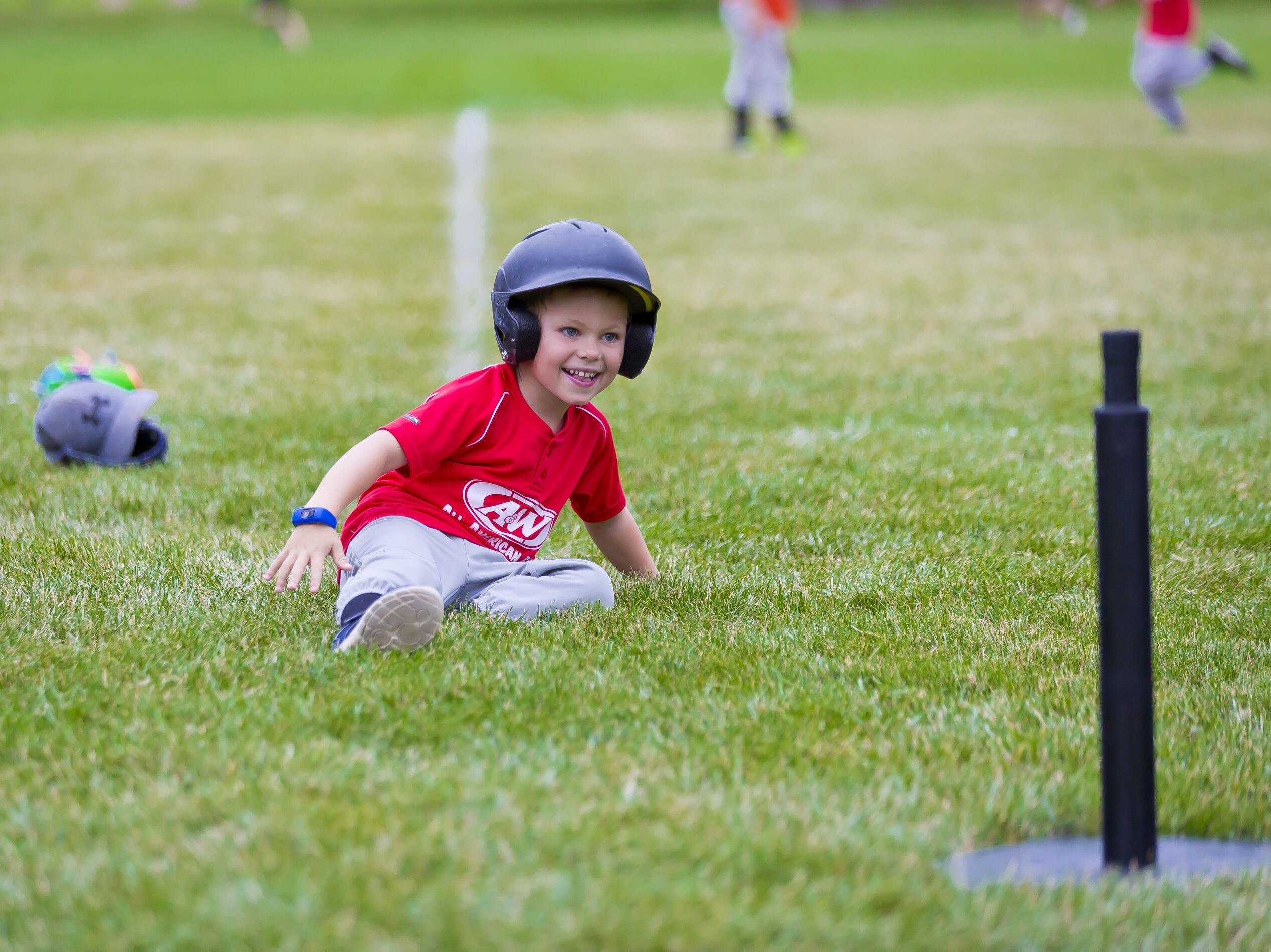 Photo of a young boy sliding into home plate