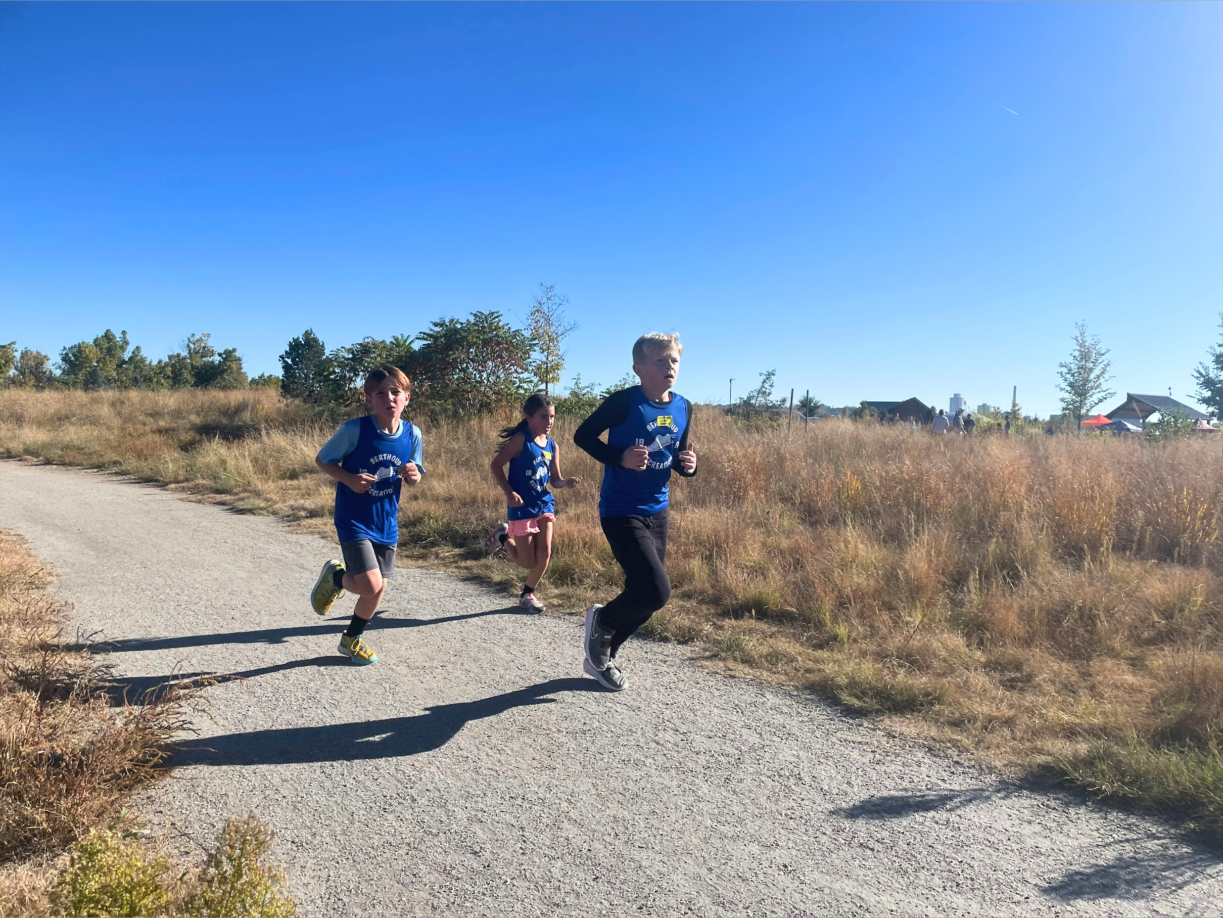 Photo of three youth cross country runners