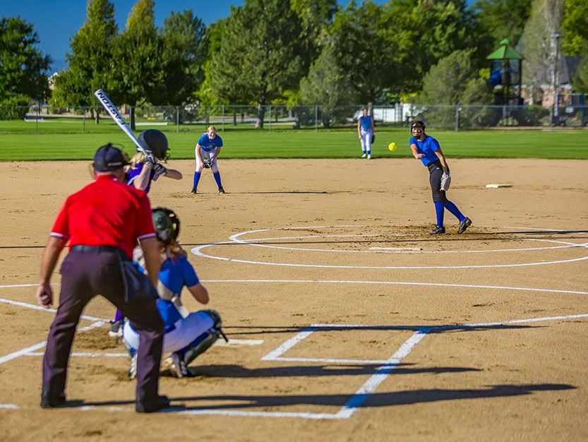 Photo of an 14U softball player pitching to a batter