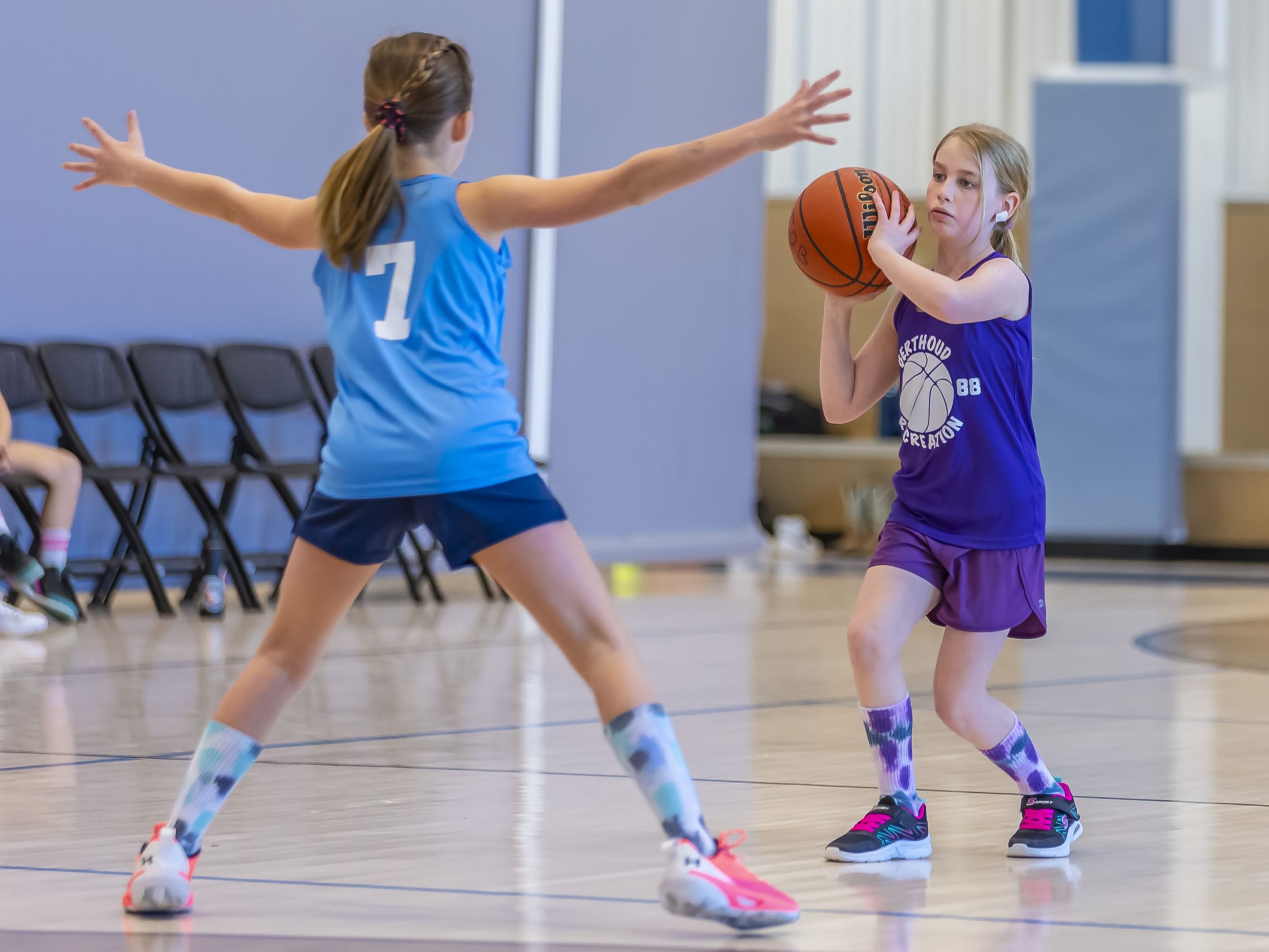 Photo of two girls playing in a basketball game