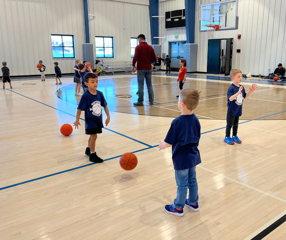 Photo of a group of kids passing basketballs