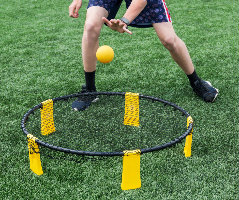Player spiking a Spikeball onto the net during a game